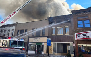 Fire Fighters Working to Put Out a Spreading Fire That is Consuming Several Downtown Webster City Buildings